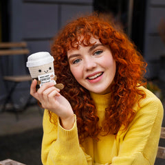 A AIFAMY Positive Coffee doll on display as cute decor with cheerful appeal