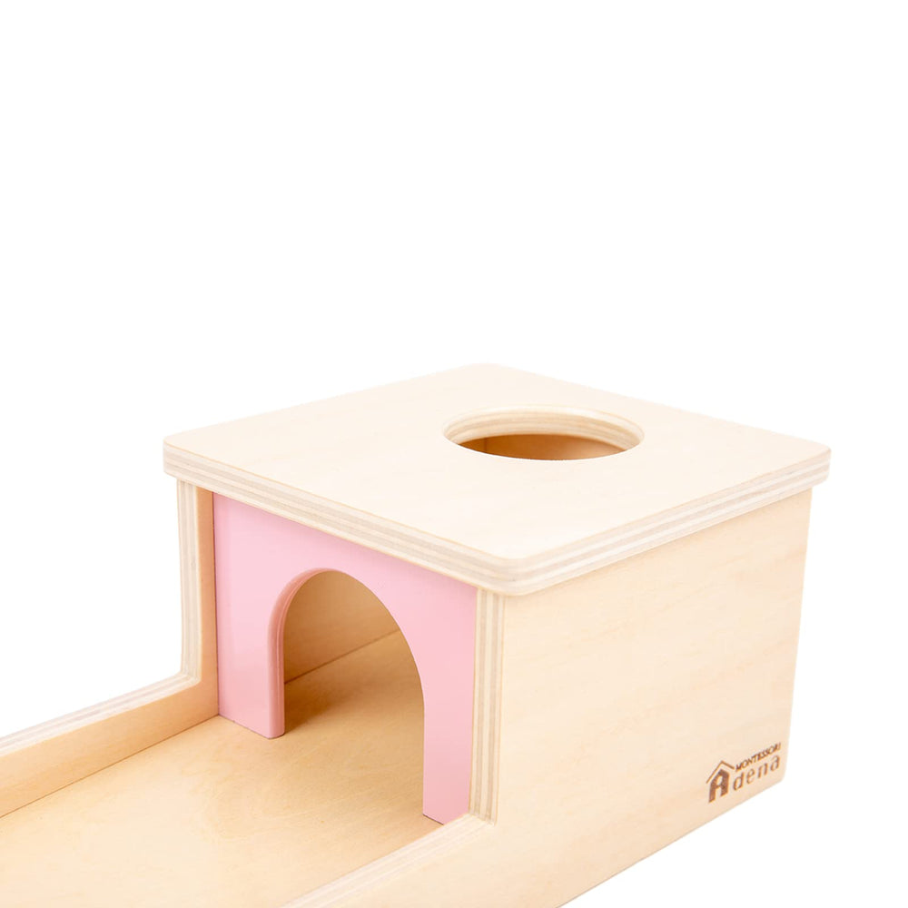 Adena Montessori object permanence box in use by a baby
