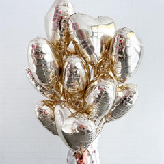 Adorely light gold heart balloons add romantic ambience to anniversaries.