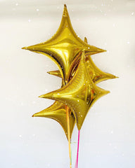 Adorely Gold Star Balloons arranged in a party bouquet for festive ambience.