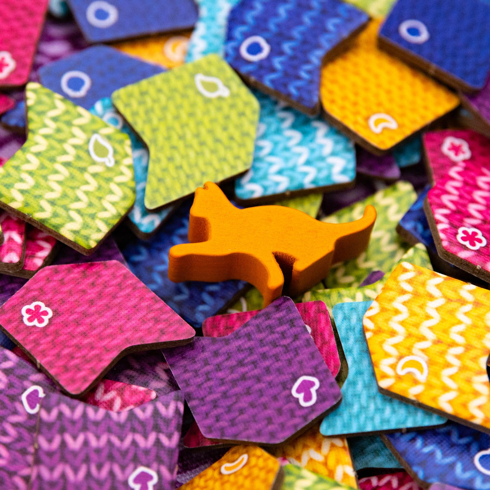 AEG Knitting Circle player mats help organize turns.