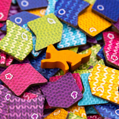 AEG Knitting Circle player mats help organize turns.