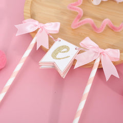 AOQURE pink bow topper doubles as a photo prop and keepsake.