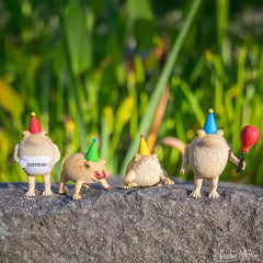 Archie McPhee rain frogs, collectible figures ideal for playful shelf accents and novelty gifting.