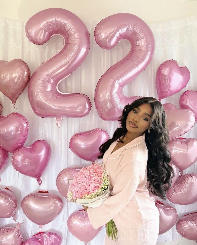 Argthjy pearl pink balloon creates bright backdrop for celebrations.