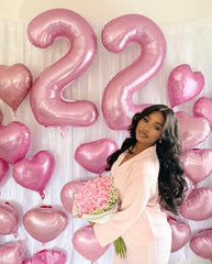 Argthjy pearl pink balloon creates bright backdrop for celebrations.