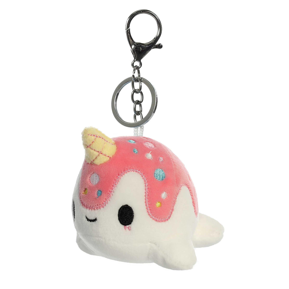 Aurora Nomwhal clip-on attached to a bag for playful flair.