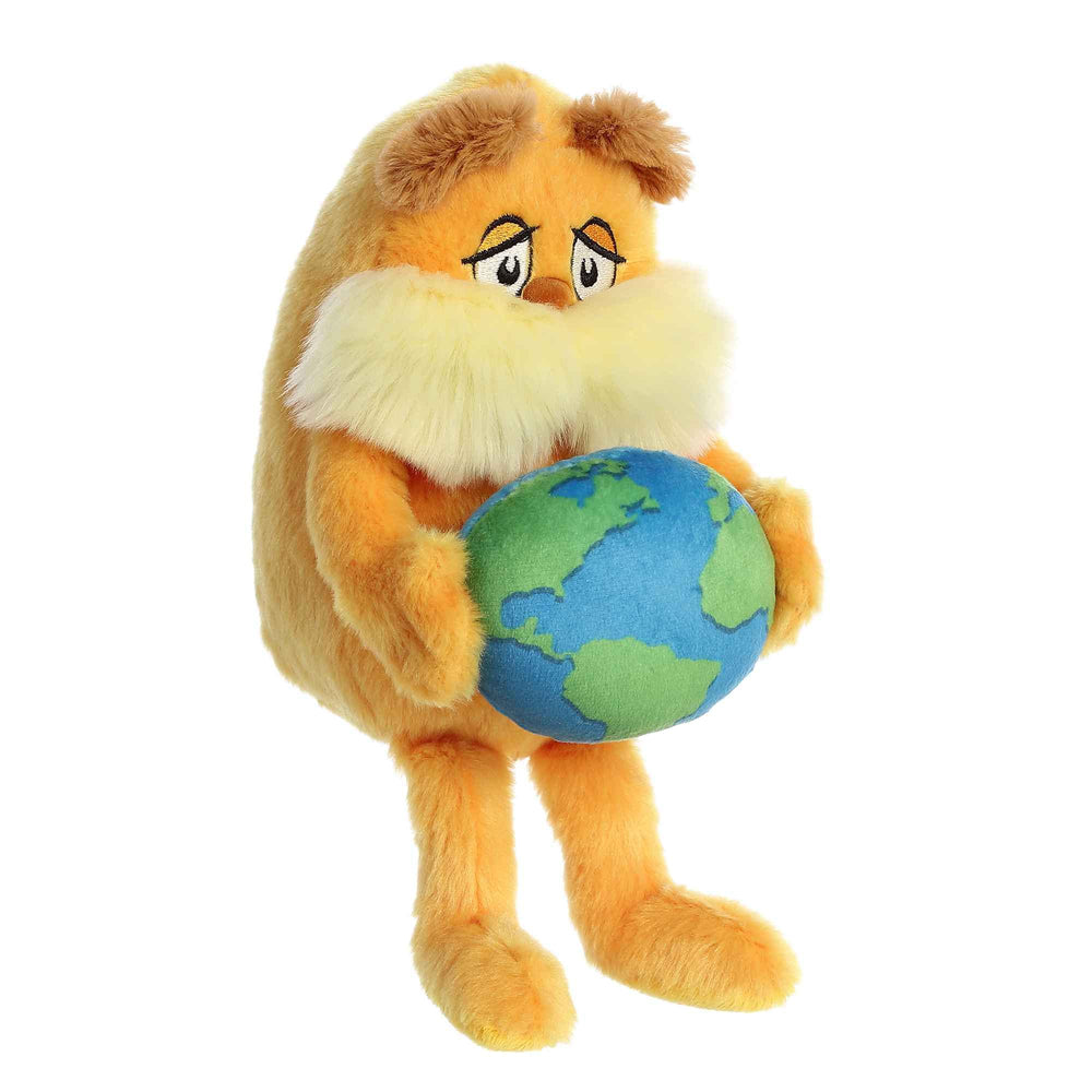 Aurora Lorax orange plush in warm lighting, perfect for bedtime stories.