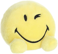 Aurora SmileyWorld Palm Pals Wink yellow close-up face highlighting soft plush and friendly expression.