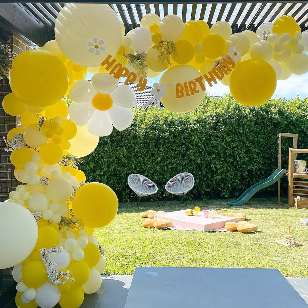awenztech gender reveal decor in pale yellow tones.