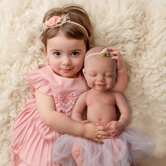 BABESIDE reborn doll in hand highlighting easy handling for children.