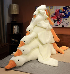 Bacmaze Goose Plush Doll on a bed during storytelling time for kids.
