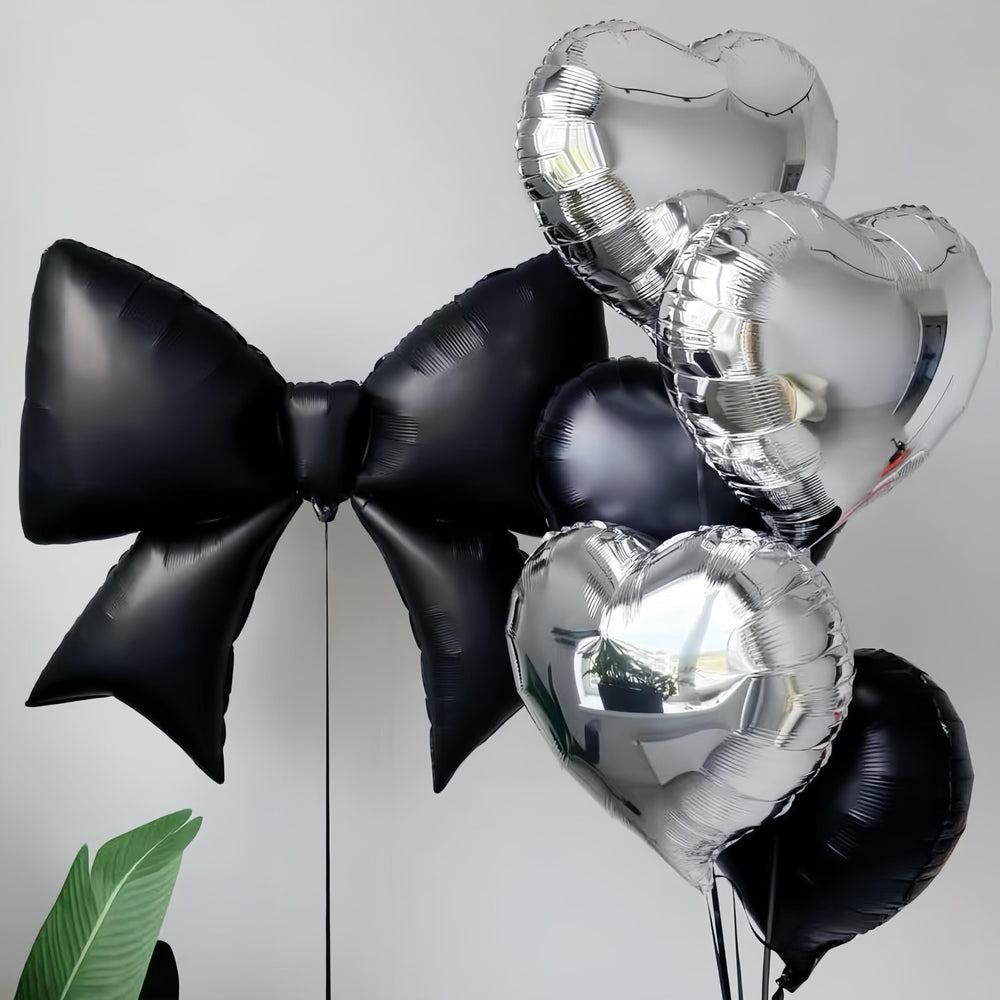 Baoonworlld black bow balloon paired with gold accents for gothic or palace-themed celebrations.