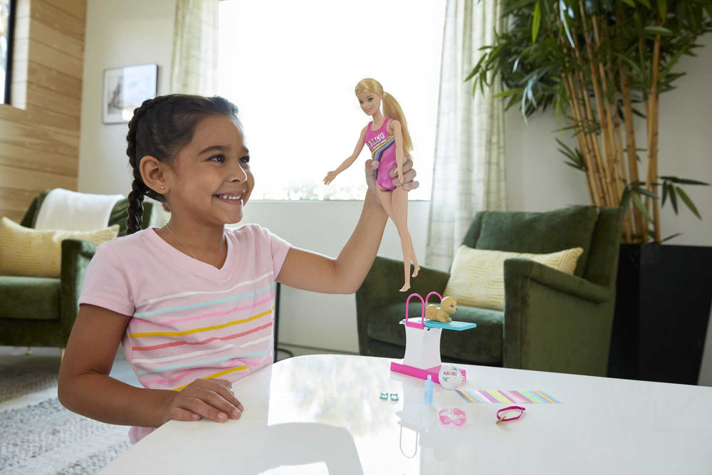 Barbie Dreamhouse Adventures Swim 'n Dive doll with waist lever activates swimming motion.
