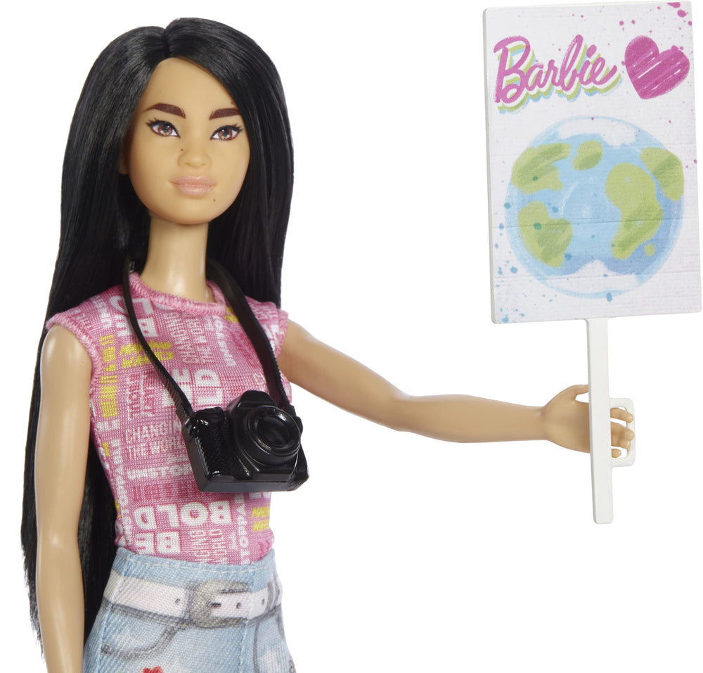 Barbie Eco-Leadership Environmental Advocate with camera and sign inspires community action.