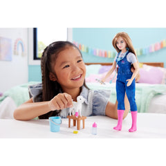 Barbie farm vet doll wears overalls and pink boots for authentic pretend care.