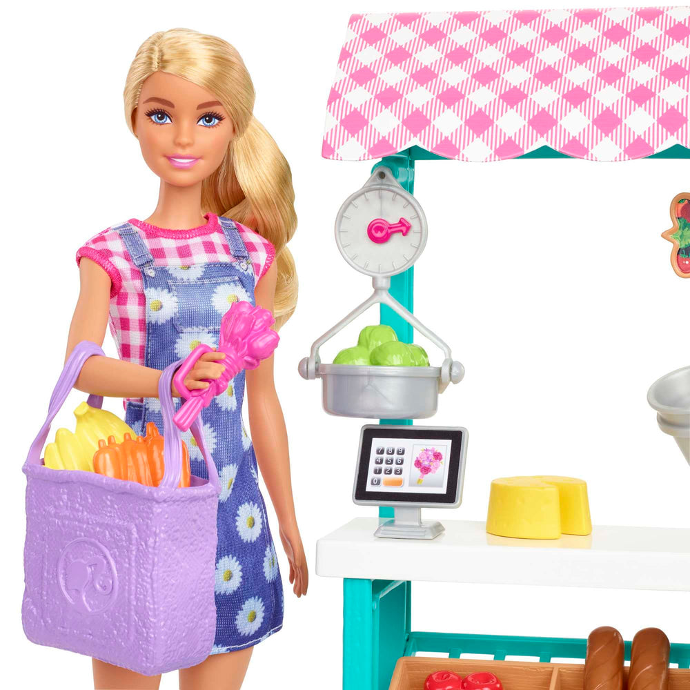 Barbie doll in gingham dress beside fruit and vegetable baskets for hands-on trading
