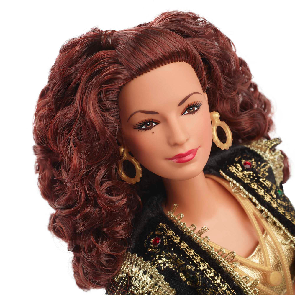 Barbie Gloria Estefan doll featuring leopard belt and gold chain for elegant styling.