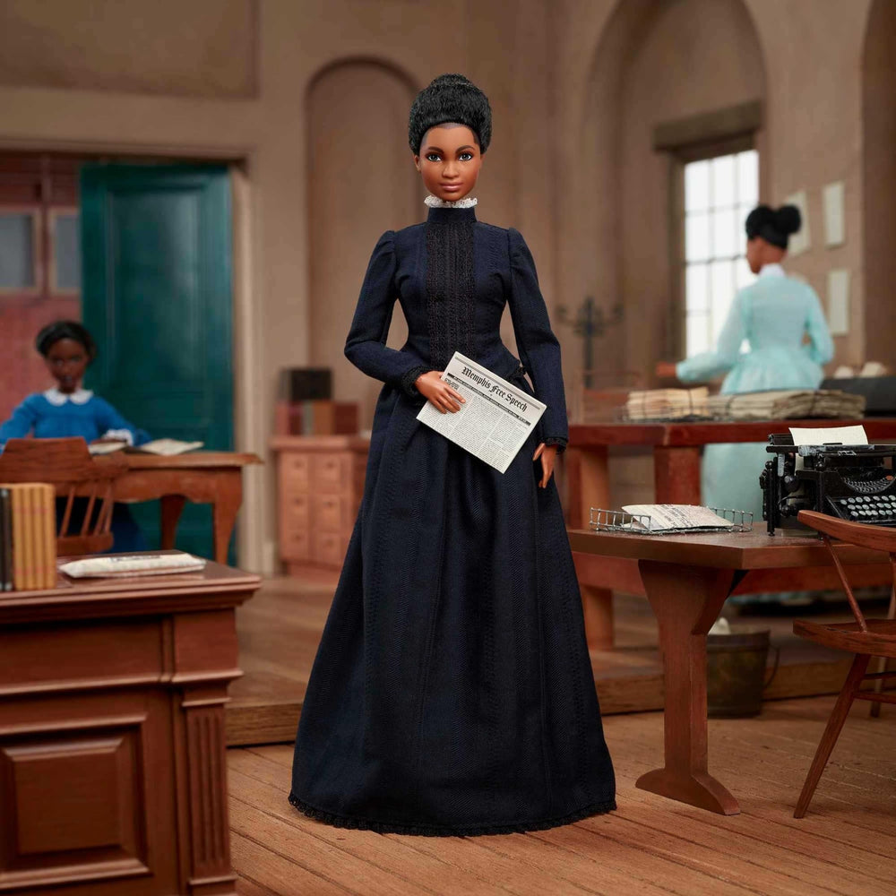 Ida B. Wells Barbie wearing blue dress with collar and waist lace details.