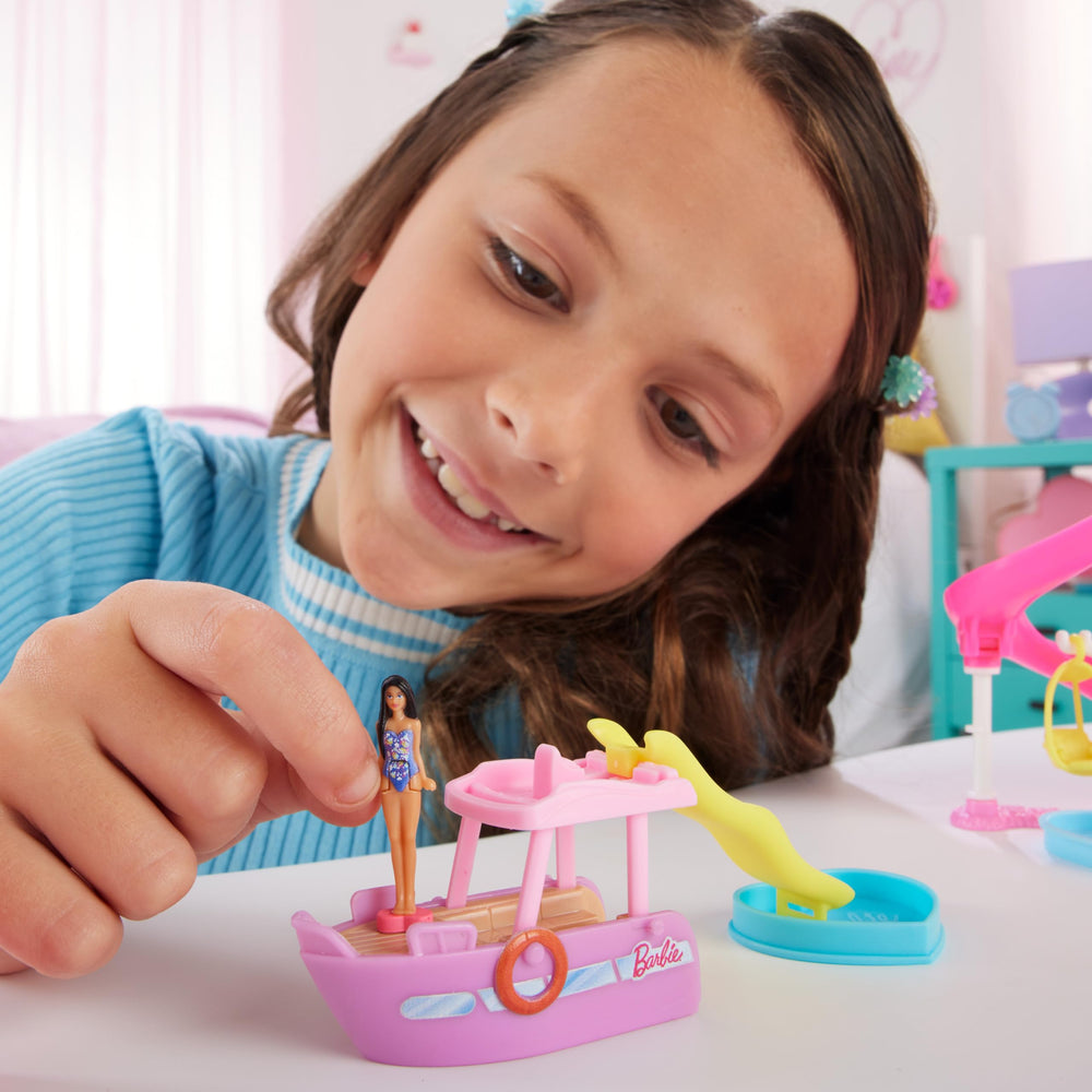Barbie Mini BarbieLand pool with slide adds splashy play moments.