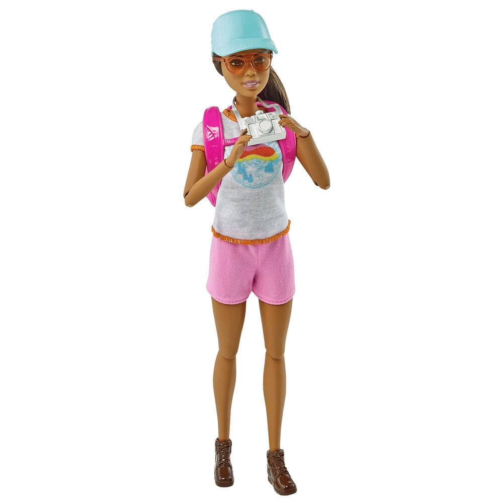 Barbie doll poses with hiking gear, camera and map for storytelling on the trail.