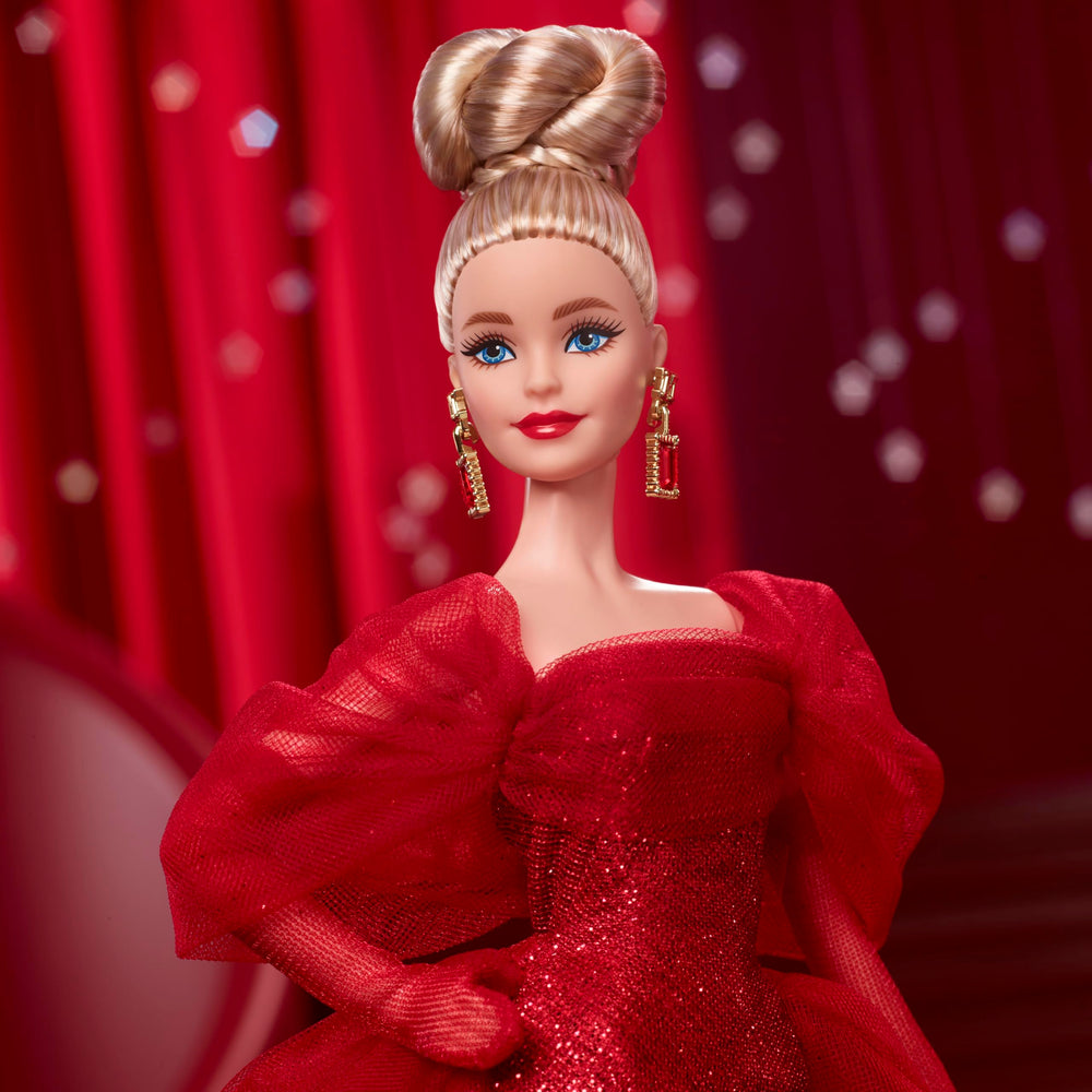 Barbie Signature doll with drop earrings and golden M adds classic charm.