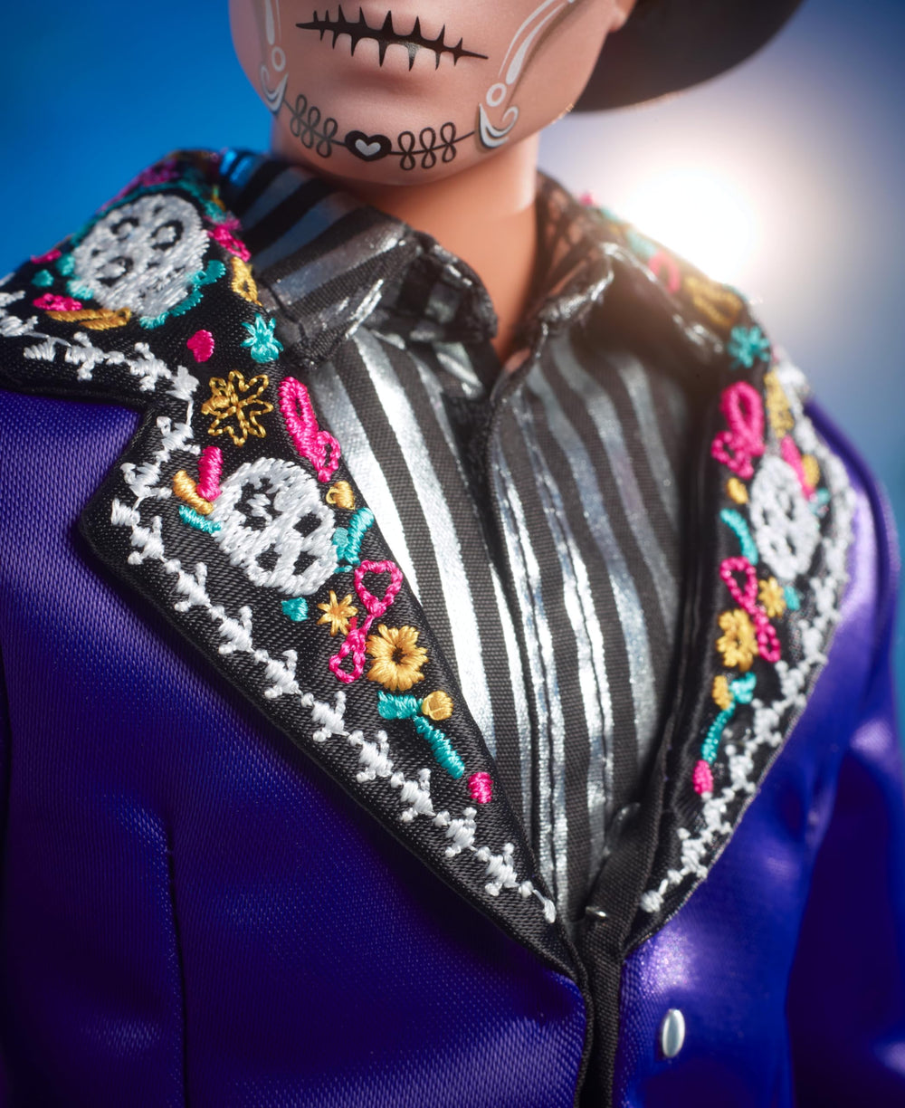 Ken's blue satin undershirt and tailored pants create a refined display look.