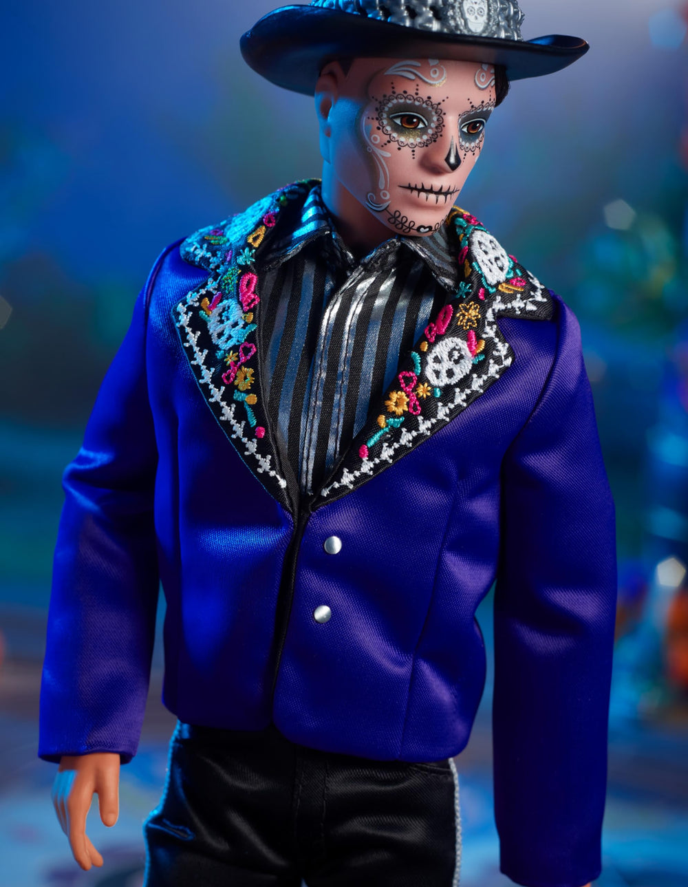 Close look at calavera face paint and bone-embroidered lapels on Ken.