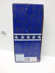 Barbie Winter Velvet doll with blue hair bow and stand, ready for elegant display.