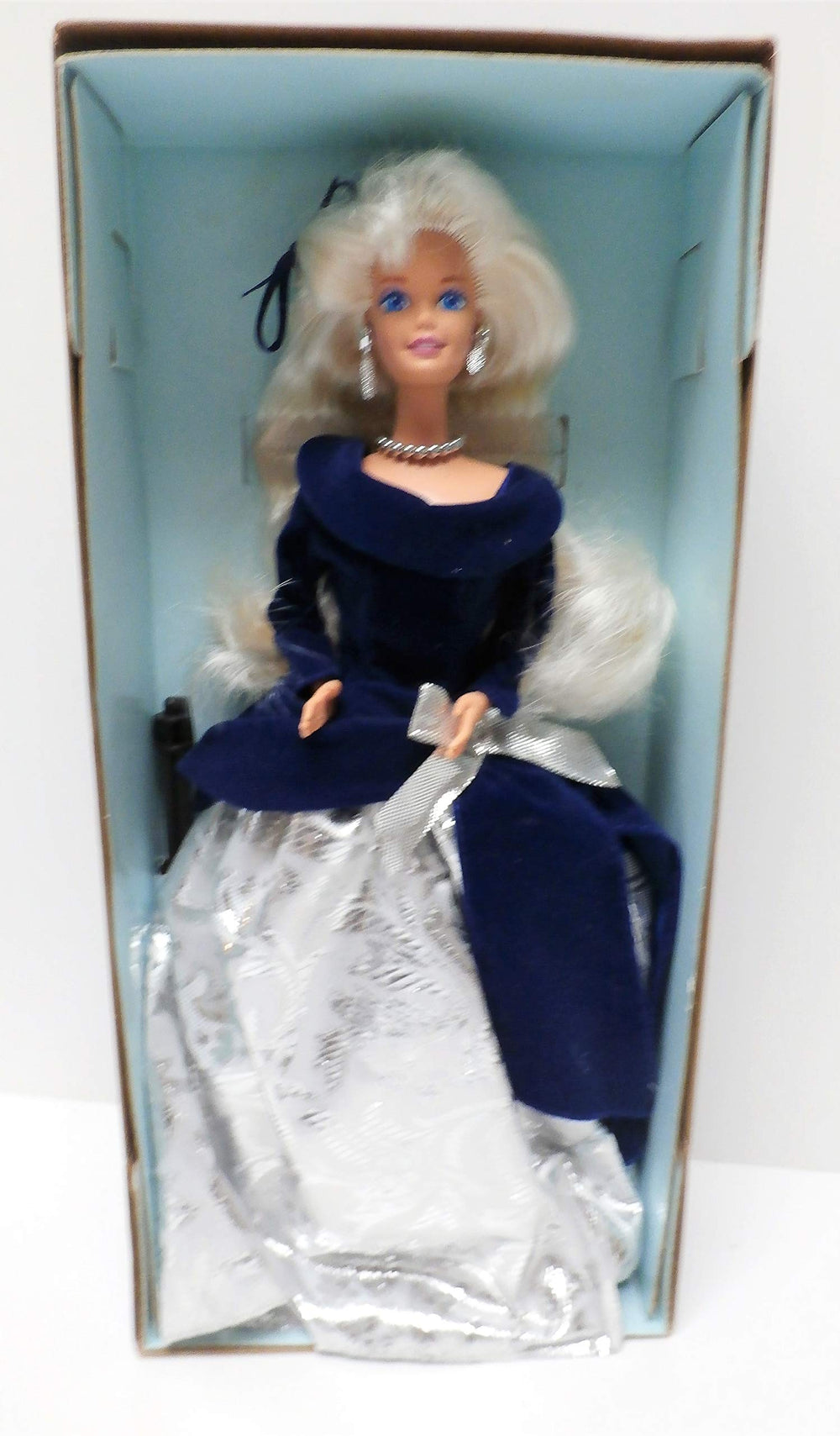 Barbie Winter Velvet doll in silver skirt and blue velvet top, ideal for display collections.