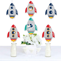 Big Dot of Happiness space party cutouts arranged as centerpieces.