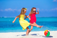 Rainbow beach ball on sand for sunny beach day.
