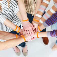 Bouiexye orange wristbands used in party décor and events.