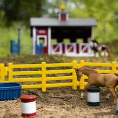 Breyer Stablemates red stable set display presents a colorful scene on a shelf
