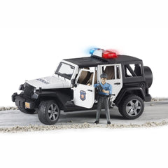 Bruder bworld policeman figure seated in the police car for realistic scenes.