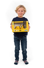 Mud guards on the Bruder compactor help shed debris during pretend-site play.