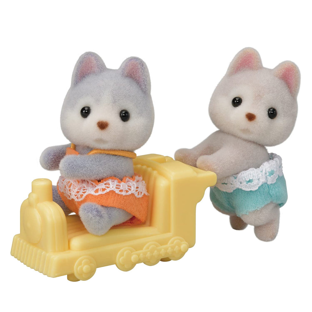 Calico Critters Husky Twins with pushcart for imaginative outdoor play.