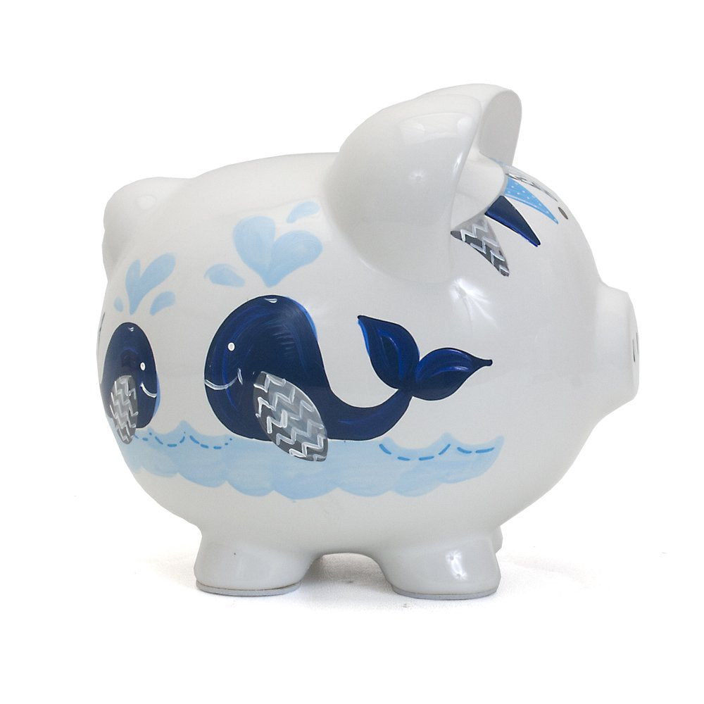 Nursery decor shot featuring Child to Cherish Piggy Bank in blue double whale design