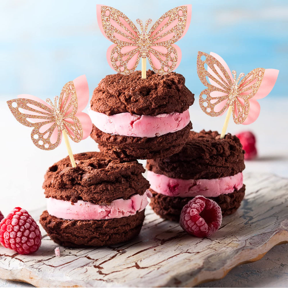 Chinco pink glitter butterflies rise above cupcakes with romantic flair.