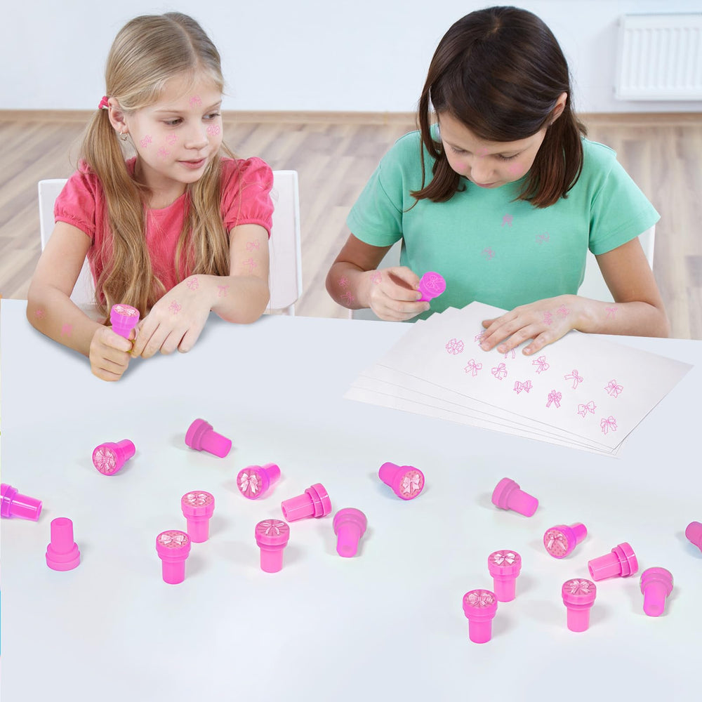 A hand using Cinrobiye pink bow stamper during craft activity.