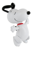 Classic wind-up Snoopy dancing toy showcasing playful motion in a tiny form.