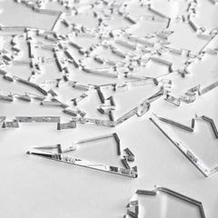 Finished CM Originals Broken Glass Puzzle displays transparent silhouettes against a neutral backdrop.