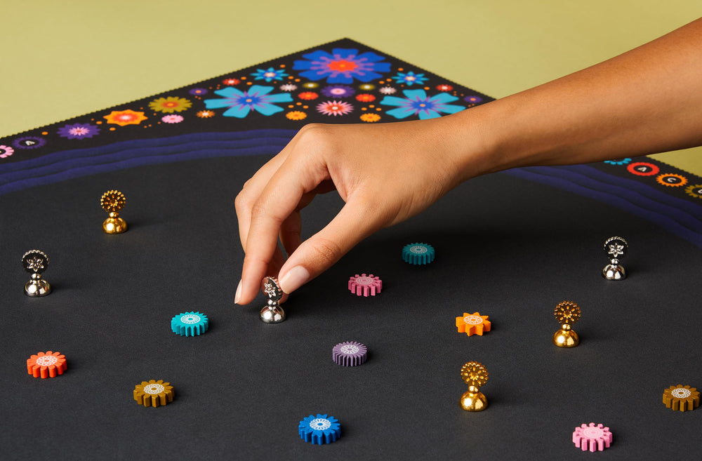 CMYK Lacuna board game mystical geometry art close-up with colorful tokens.