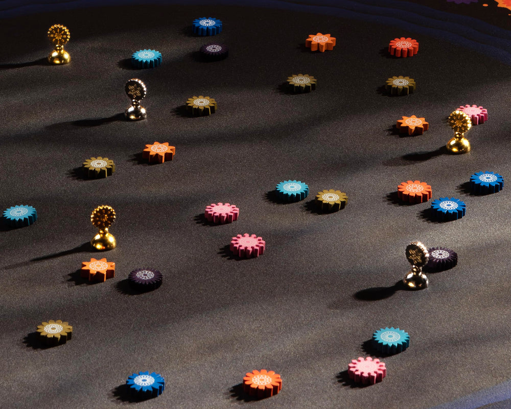 CMYK Lacuna board game packaging interior showing components and quick-start guide.