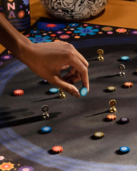 CMYK Lacuna board game play scene with two players and calm focus.