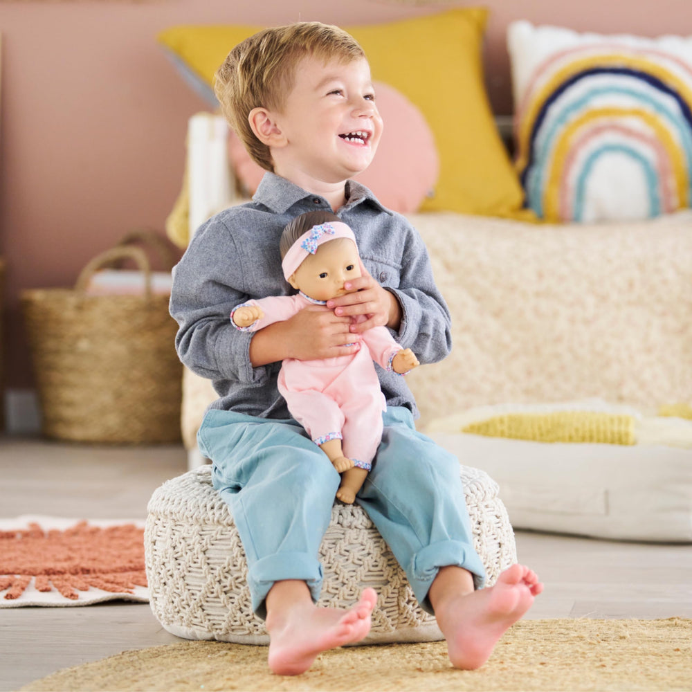 Corolle Mila bean-filled body enables lifelike posing for nurturing activities.