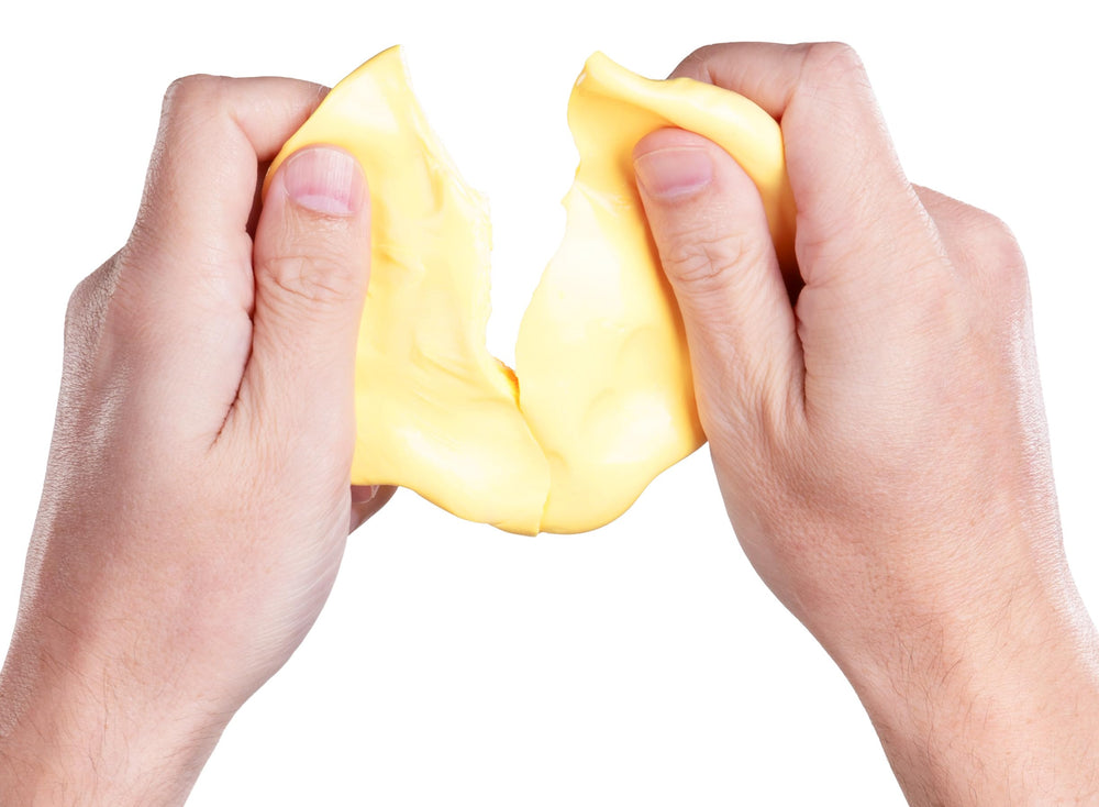 Crazy Aaron's Better Butter Thinking Putty on a desk offers a calming break option.