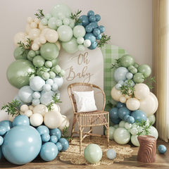 Crossfingers balloon arch kit assembled in dusty blue and sage green for a dramatic backdrop.