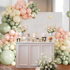 Crossfingers pink-and-green balloon garland enhances baby showers with soft colors.