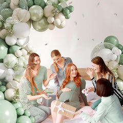 CROSSFINGERS sand white and clear balloons blend with sage-green tones.
